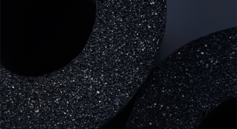 Close-up web news image of black elastomeric pipe insulation sections.