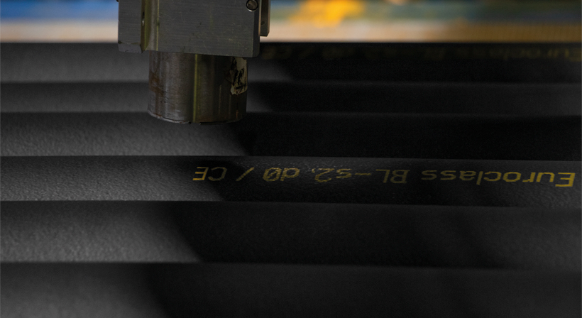 Wide web news crop of black K-FLEX insulation material with printed technical markings.