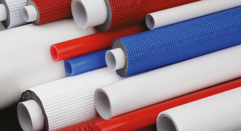Wide crop of red, white and blue K-FLEX insulated and uninsulated multilayer pipes.