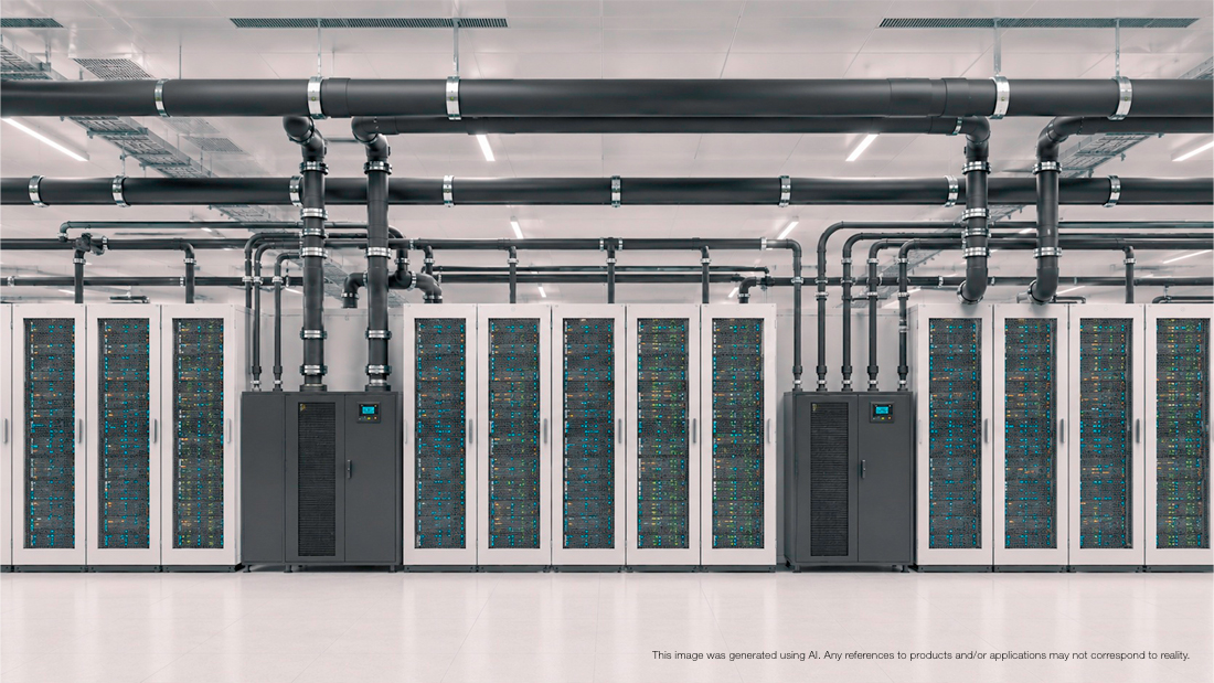 Data center cooling system with insulated overhead pipes above server racks.