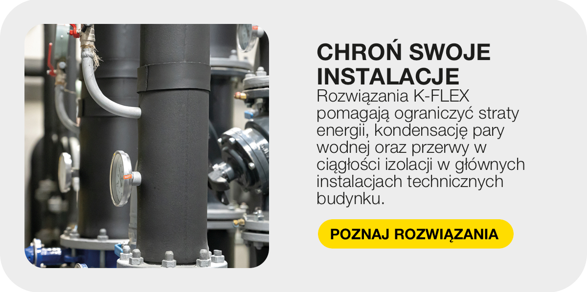 Czarna izolacja termiczna na rurze z termometrem w instalacji technicznej budynku.